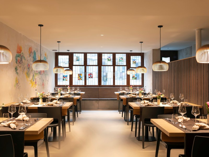 Renoviertes Restaurant Schützenstube, Gaststube mit gedeckten Tischen und Wandmalerei